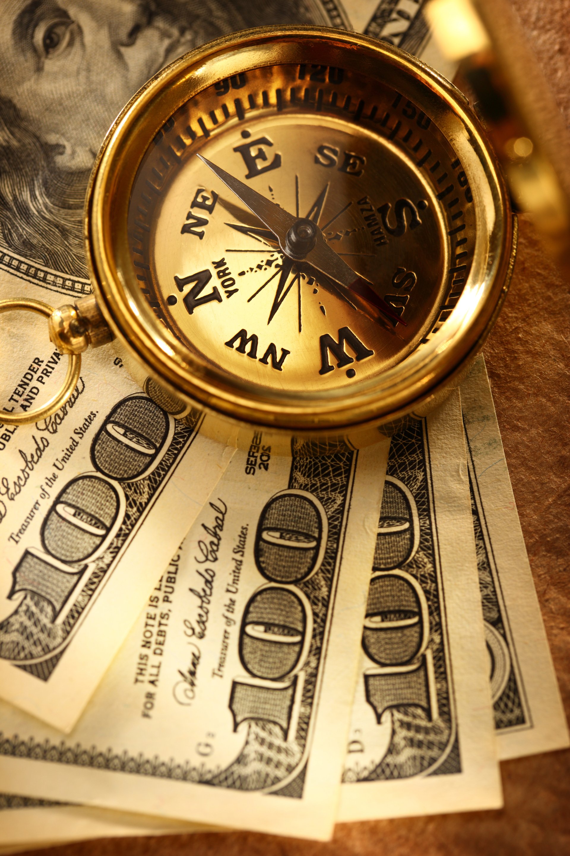 Golden vintage compass and money